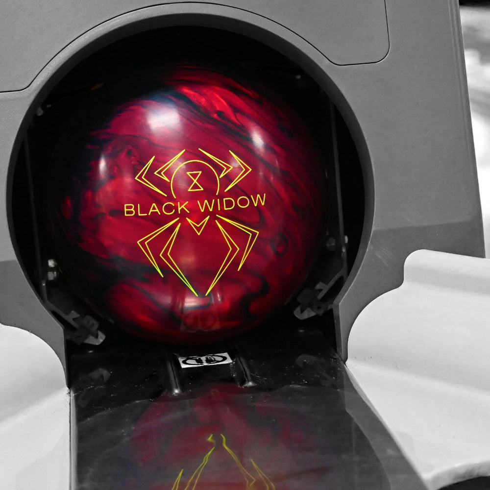 Red and black bowling ball with 'Black Widow' logo on a gray background